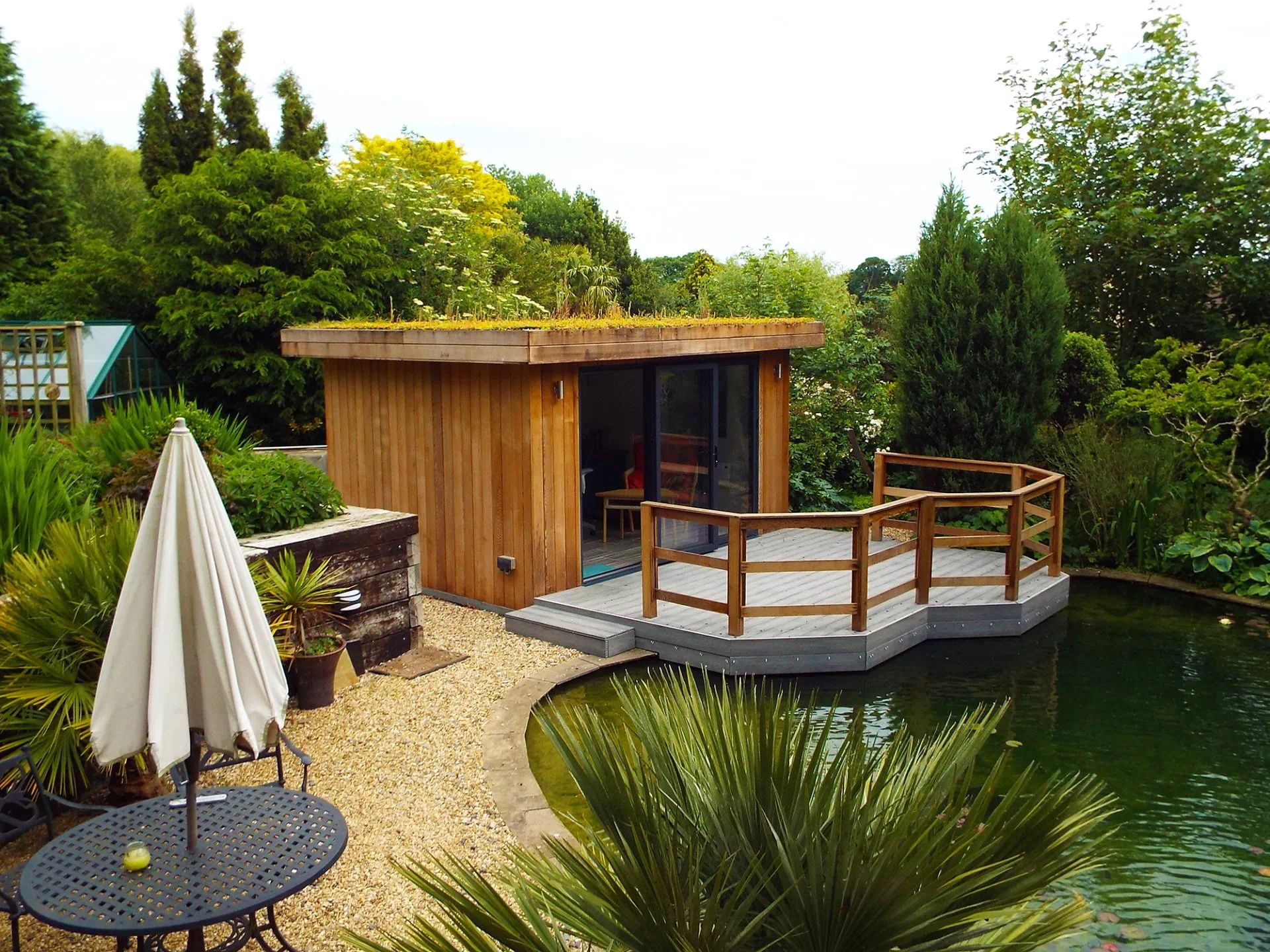 Light Grey Composite Decking Outside A Wodden Summer House - Assured Composite