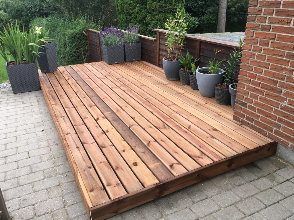 timber decking in small garden - Assured Composite